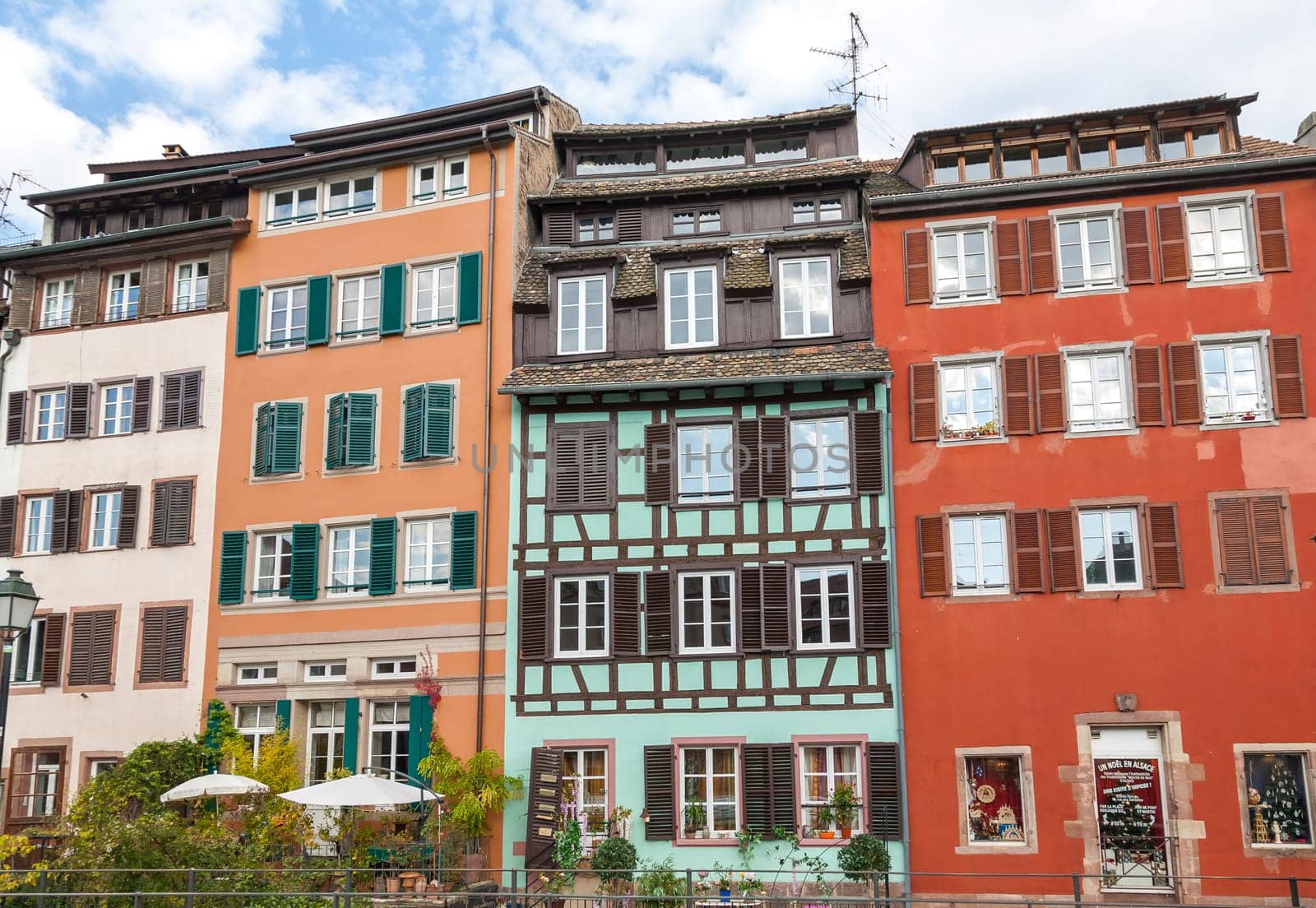 Strasbourg, water canal in Petite France area. timbered multicolored houses and trees in Grand Ile. Alsace, France.