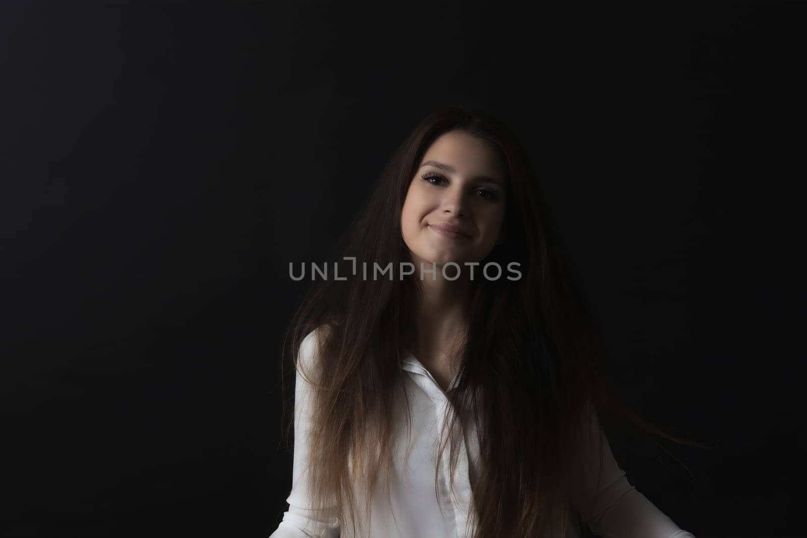 Portrait of smiling long haired girl. Horizontally.