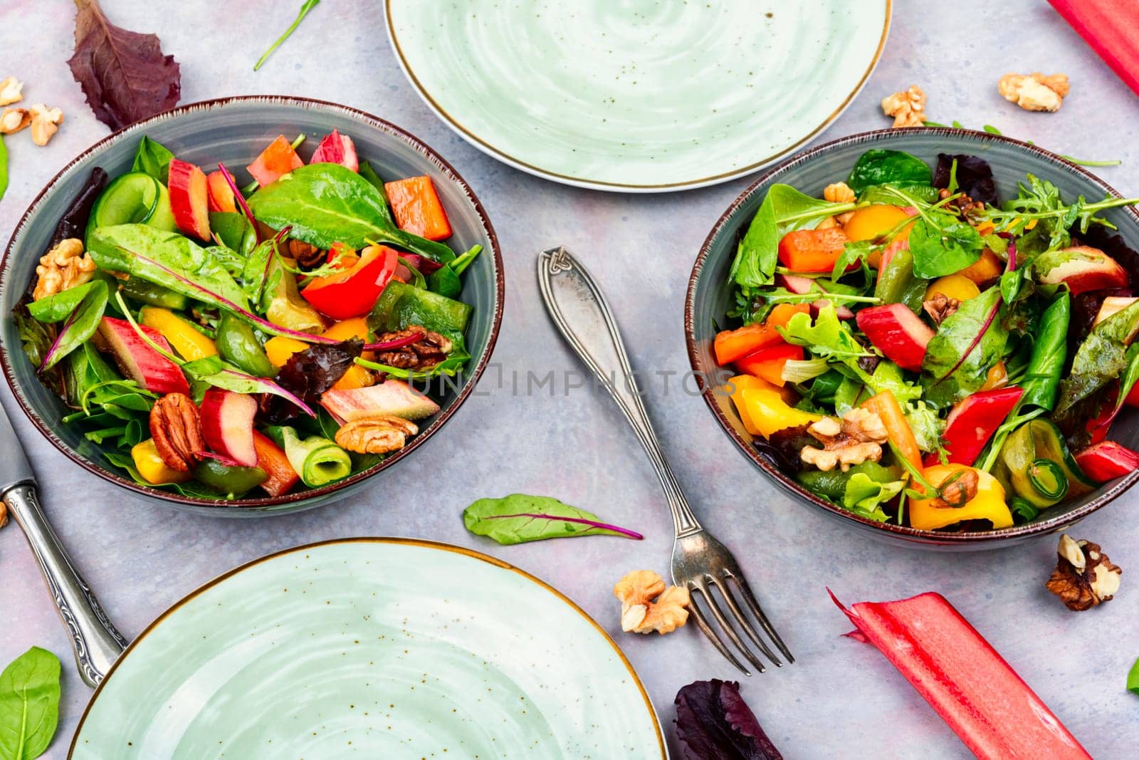 Vitamin delicious salad of rhubarb, bell pepper, herbs and nuts in bowl. Space for text