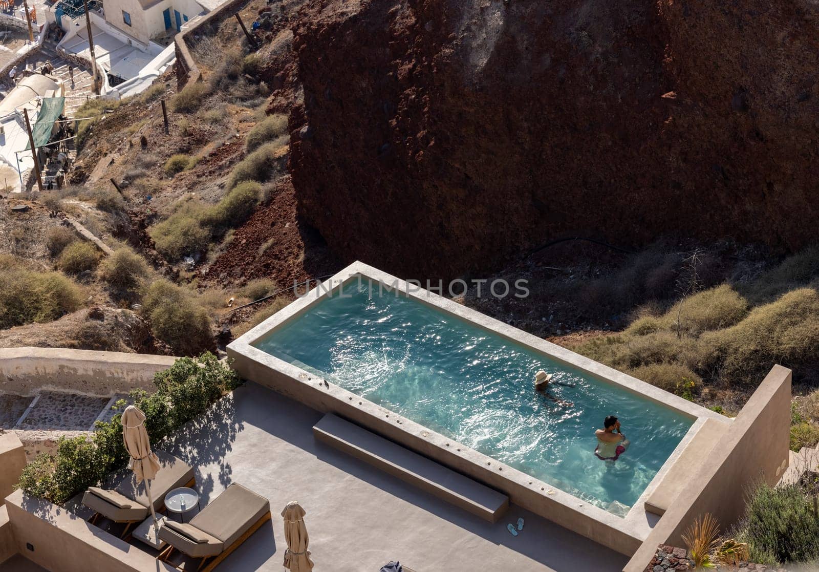 Oia, Santorini, Greece - June 28, 2021: house with terrace, pool and a beautiful view in Oia on Santorini island, Greece