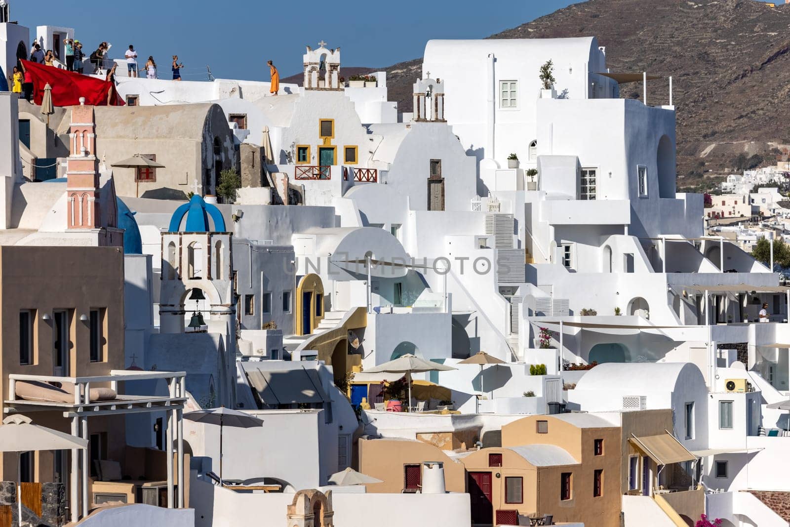 Oia, Santorini, Greece - June 28, 2021: Whitewashed houses in Oia on Santorini island, Cyclades, Greece