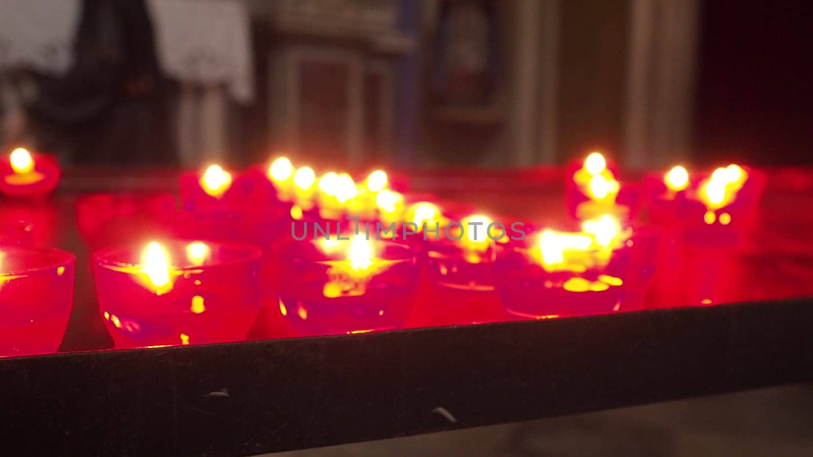 Memorial Day with candle. Commemorative candles are lit. Candle flames burn in the cemetery. Burning candles in the catholic church in Dubrovnik Croatia. Lots of candles. The flame sways in the draft