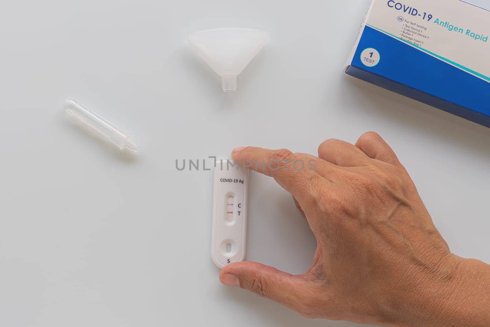 Coronavirus Covid-19 antigen test with positive result on white background.