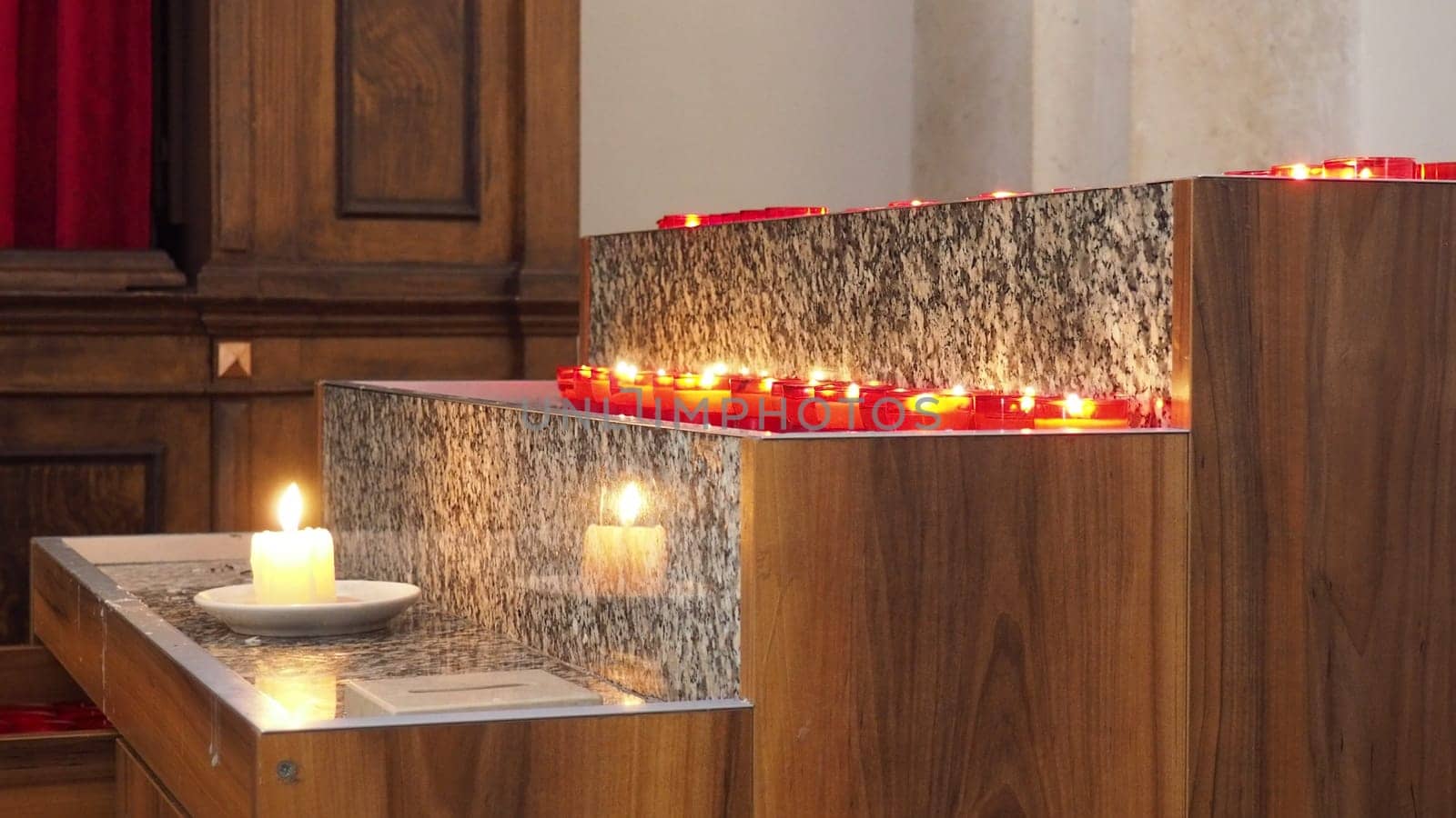 Memorial Day with candle. Commemorative candles are lit. Candle flames burn in the cemetery. Burning candles in the catholic church in Dubrovnik Croatia. Lots of candles. The flame sways in the draft