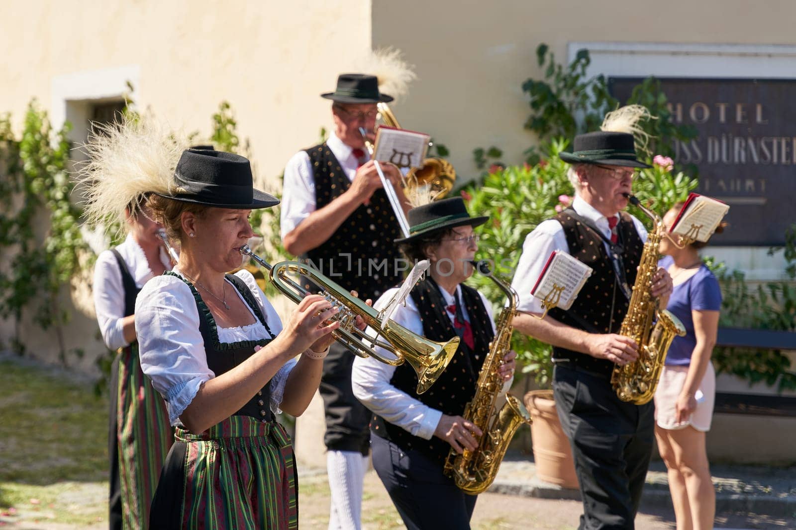 Members of the brass band Dürnstein in traditional costumes during a procession on Corpus Christi in front of the castle in Dürnstein