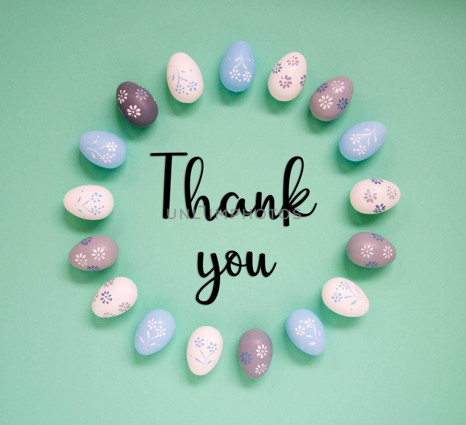 Flat Lay With English Text Thank You. Easter Egg Arrangement, Decoration And Ornament. Light Green Paper Background