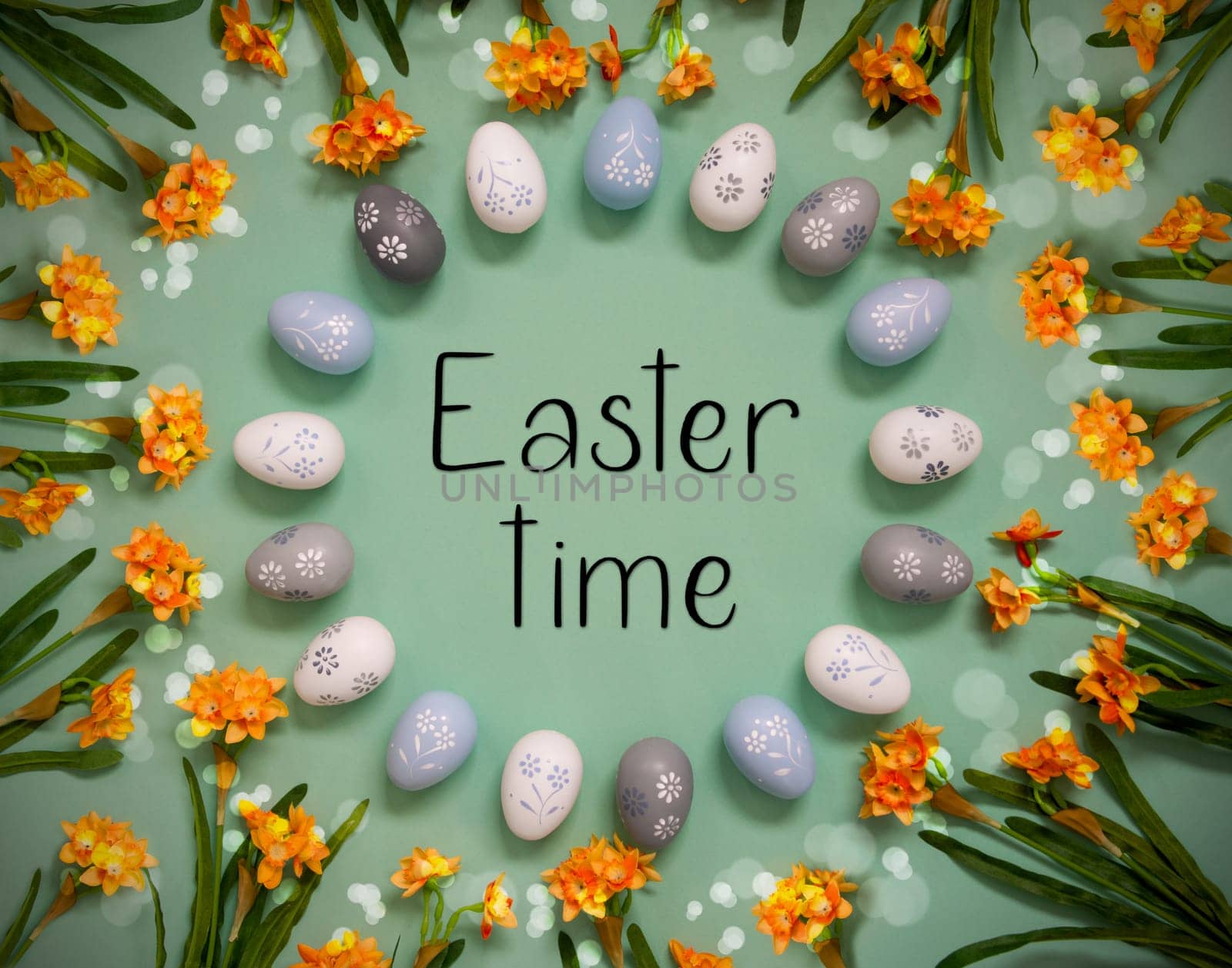 Flat Lay With English Text Easter Time. Easter Egg Decoration With Orange Spring Flowers. Light Green Paper Background With Bright And Shiny Light Effect.