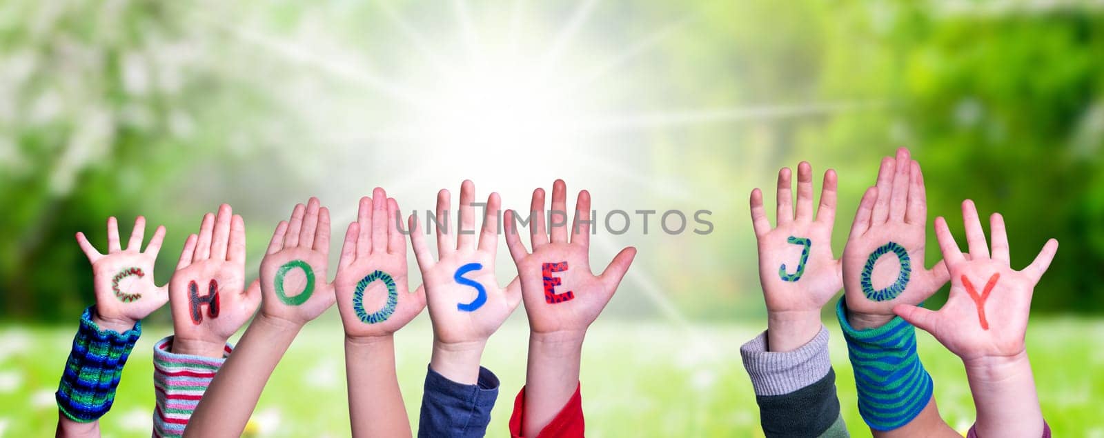 Children Hands Building Colorful English Word Choose Joy. Sunny Green Grass Meadow As Background.