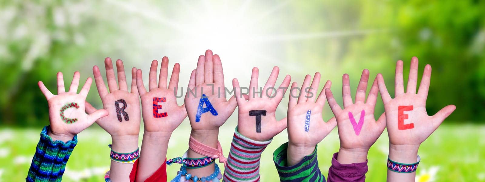 Children Hands Building Colorful English Word Creative. Sunny Green Grass Meadow As Background.