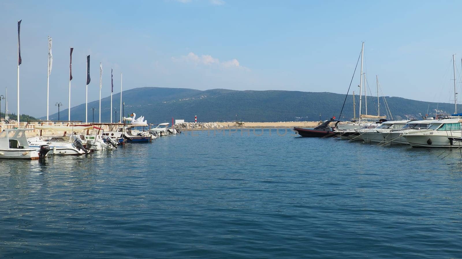Meljine, Herceg Novi, Montenegro, August 13 2022 Boats, yachts and ships are at anchor. Moored ships in the parking lot. Adriatic Sea Mediterranean. Travel business. Sea travel and sports. Summertime