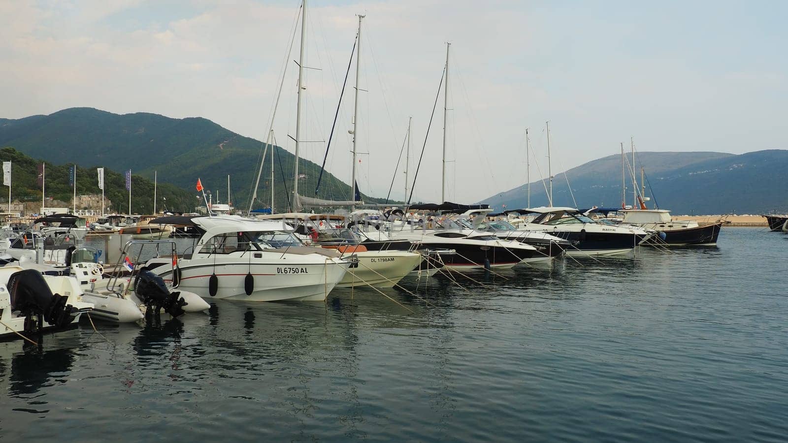 Meljine, Herceg Novi, Montenegro, August 13 2022 Boats, yachts and ships are at anchor. Moored ships in the parking lot. Adriatic Sea Mediterranean. Travel business. Sea travel and sports. Summertime
