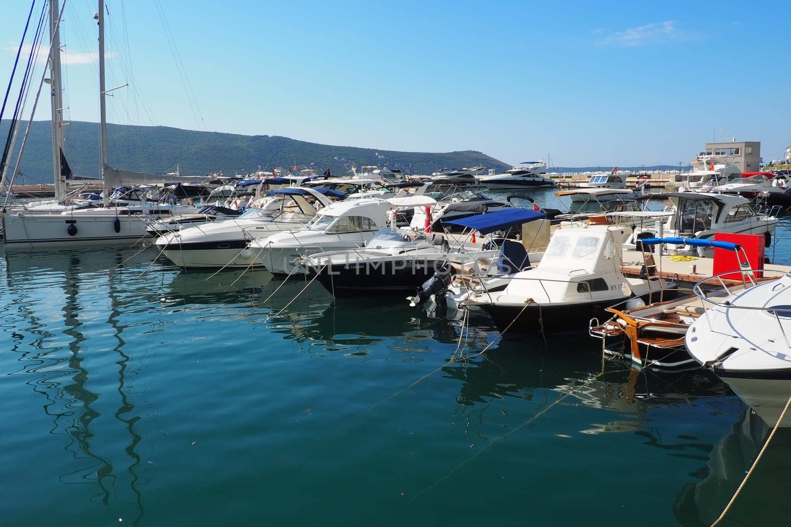 Meljine, Herceg Novi, Montenegro, August 13 2022 Boats, yachts and ships are at anchor. Moored ships in the parking lot. Adriatic Sea Mediterranean. Travel business. Sea travel and sports. Summertime
