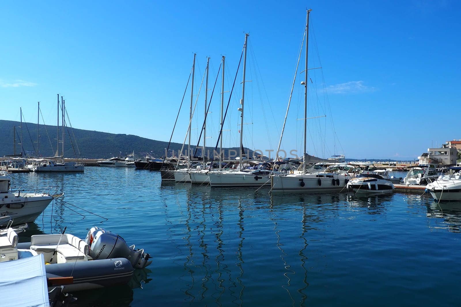 Meljine, Herceg Novi, Montenegro, August 13 2022 Boats, yachts and ships are at anchor. Moored ships in the parking lot. Adriatic Sea Mediterranean. Travel business. Sea travel and sports. Summertime