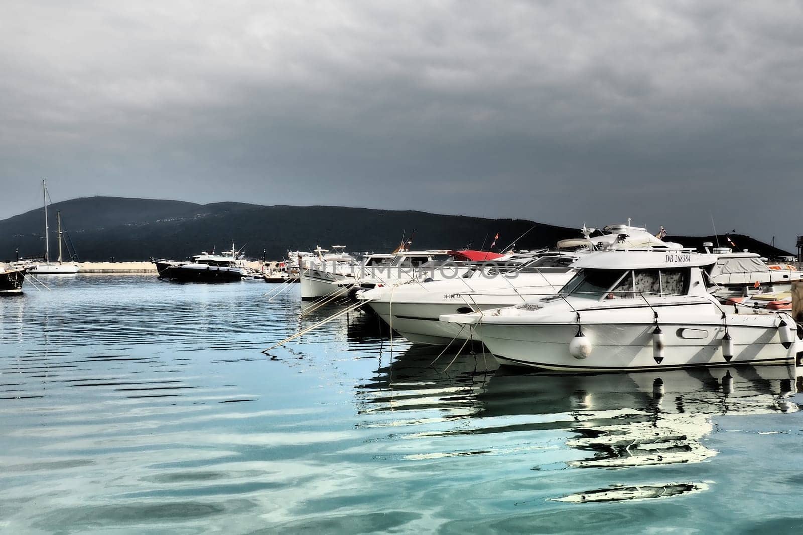 Meljine, Herceg Novi, Montenegro, August 13 2022 Boats, yachts and ships are at anchor. Moored ships in the parking lot. Adriatic Sea Mediterranean. Travel business. Sea travel and sports. Summertime