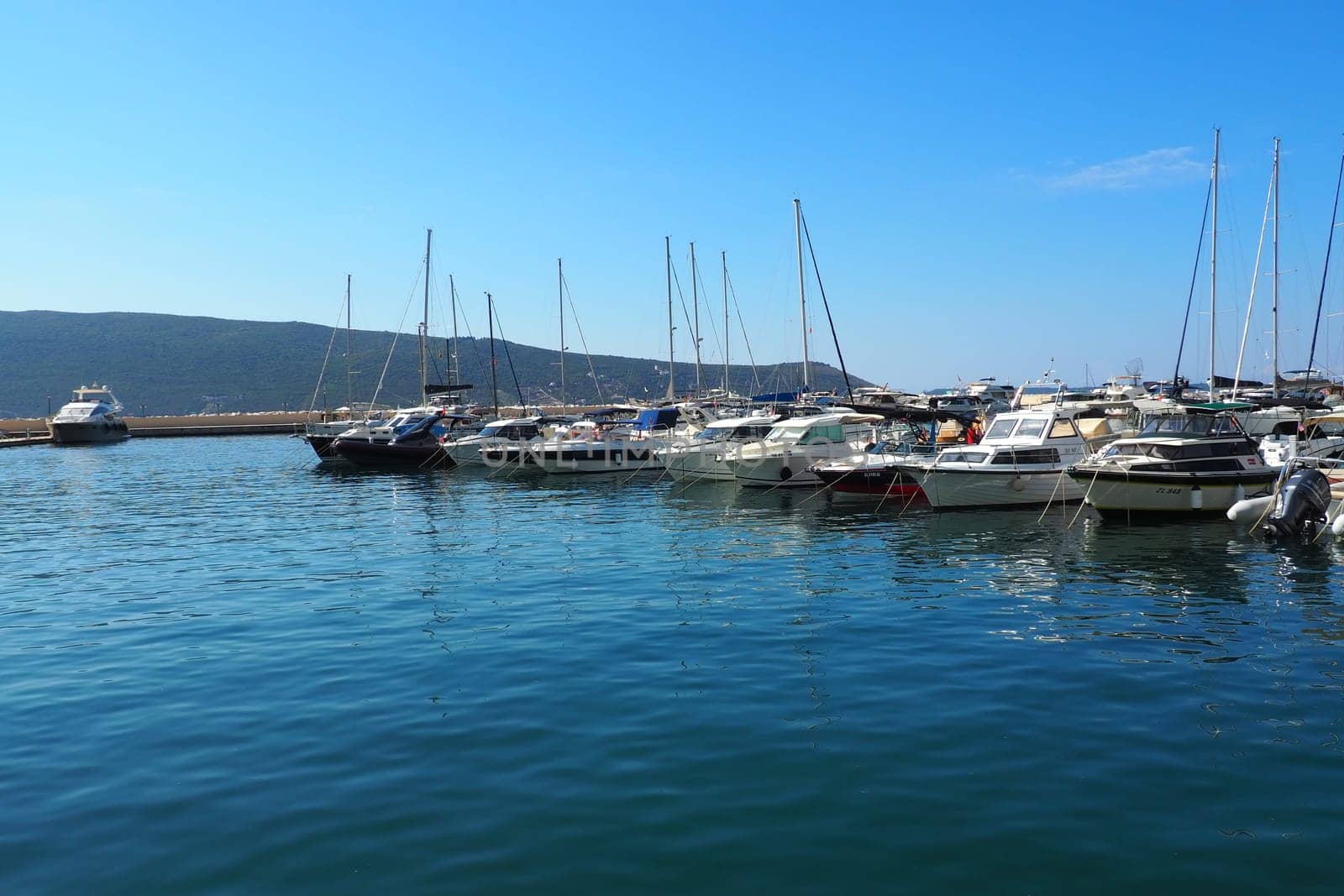 Meljine, Herceg Novi, Montenegro, August 13 2022 Boats, yachts and ships are at anchor. Moored ships in the parking lot. Adriatic Sea Mediterranean. Travel business. Sea travel and sports. Summertime