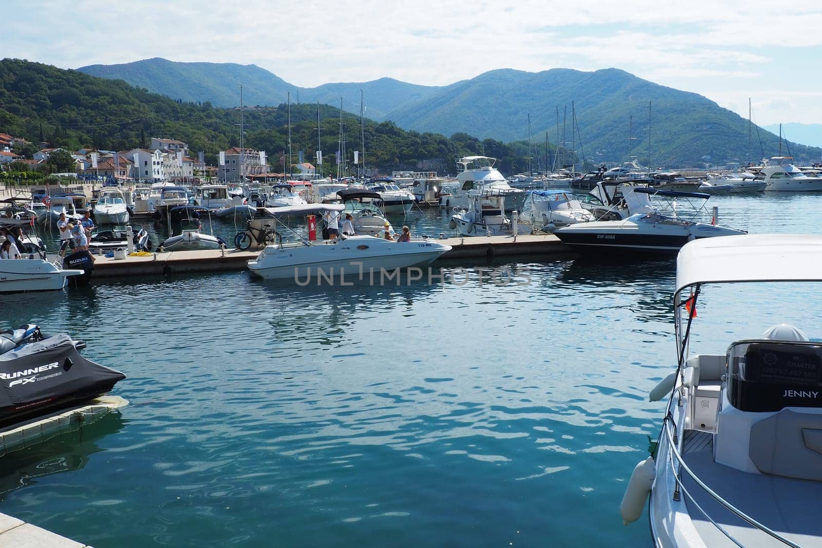 Meljine, Herceg Novi, Montenegro, August 13 2022 Boats, yachts and ships are at anchor. Moored ships in the parking lot. Adriatic Sea Mediterranean. Travel business. Sea travel and sports. Summertime