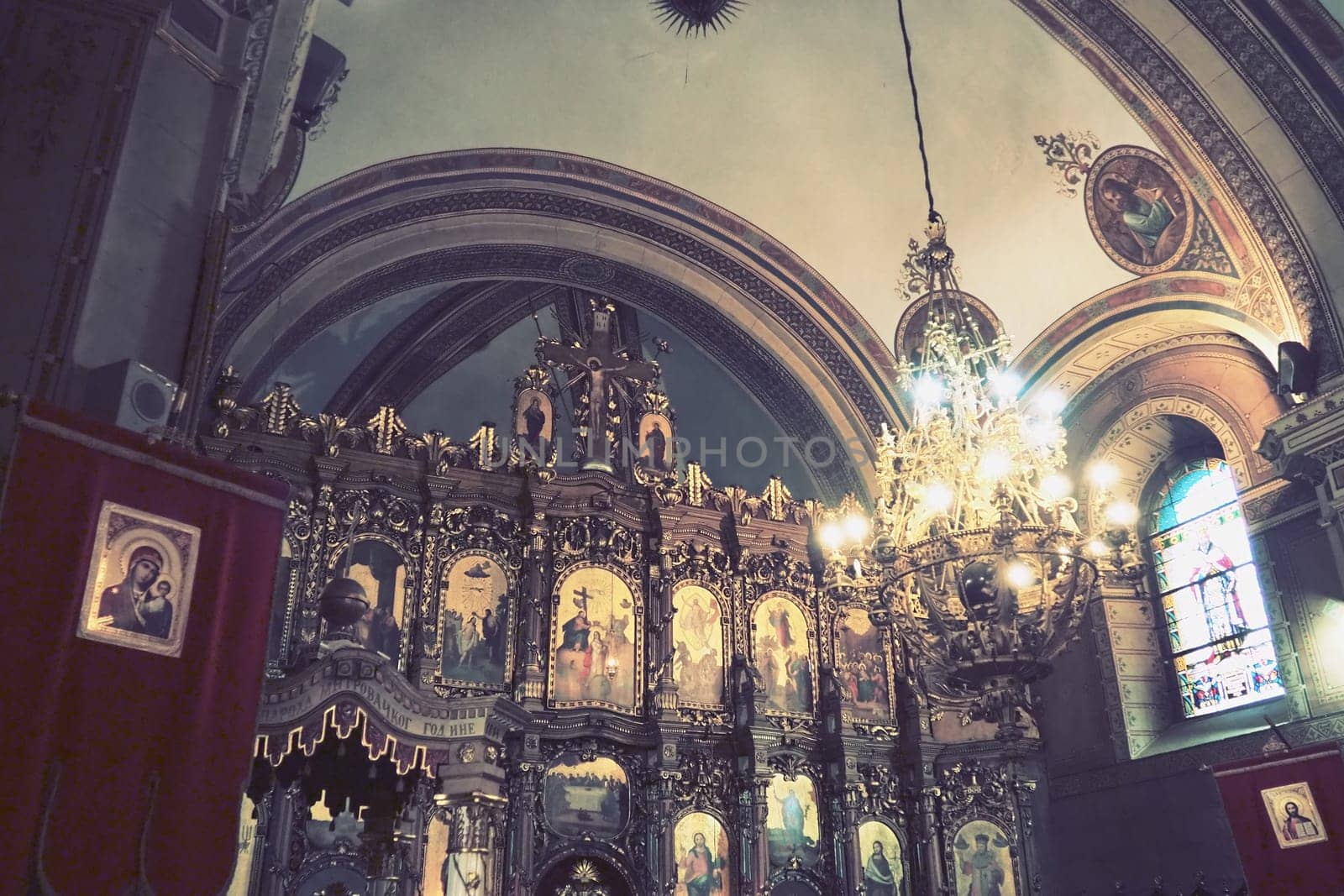 Sremska Mitrovica, Serbia 26 June 2022, Basilica of St. Demetrius, Sabor Church. Altar, icons, a large church chandelier under the arch. Arches and church utensils. Neoclassical architecture. Interior