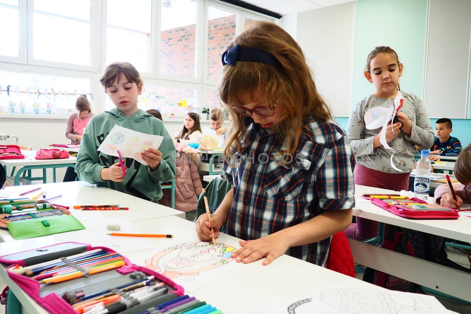 Children 9-10 years old, boys and girls, make homemade crafts at the lesson. Modern standards of education, development of creative abilities and fine motor skills at school April 9, 2022 Serbia, Srem