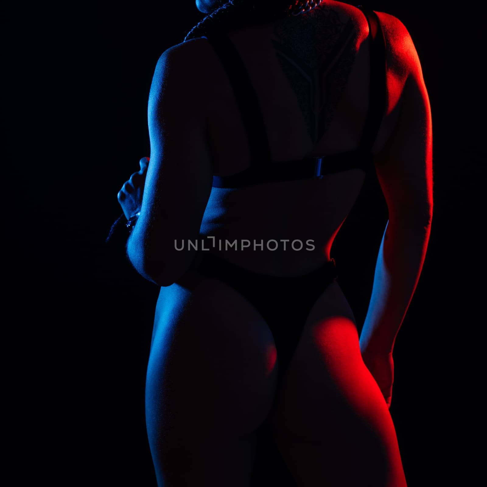 Sporty female with great abdominal muscles in a black sportswear. A great sport body close up.