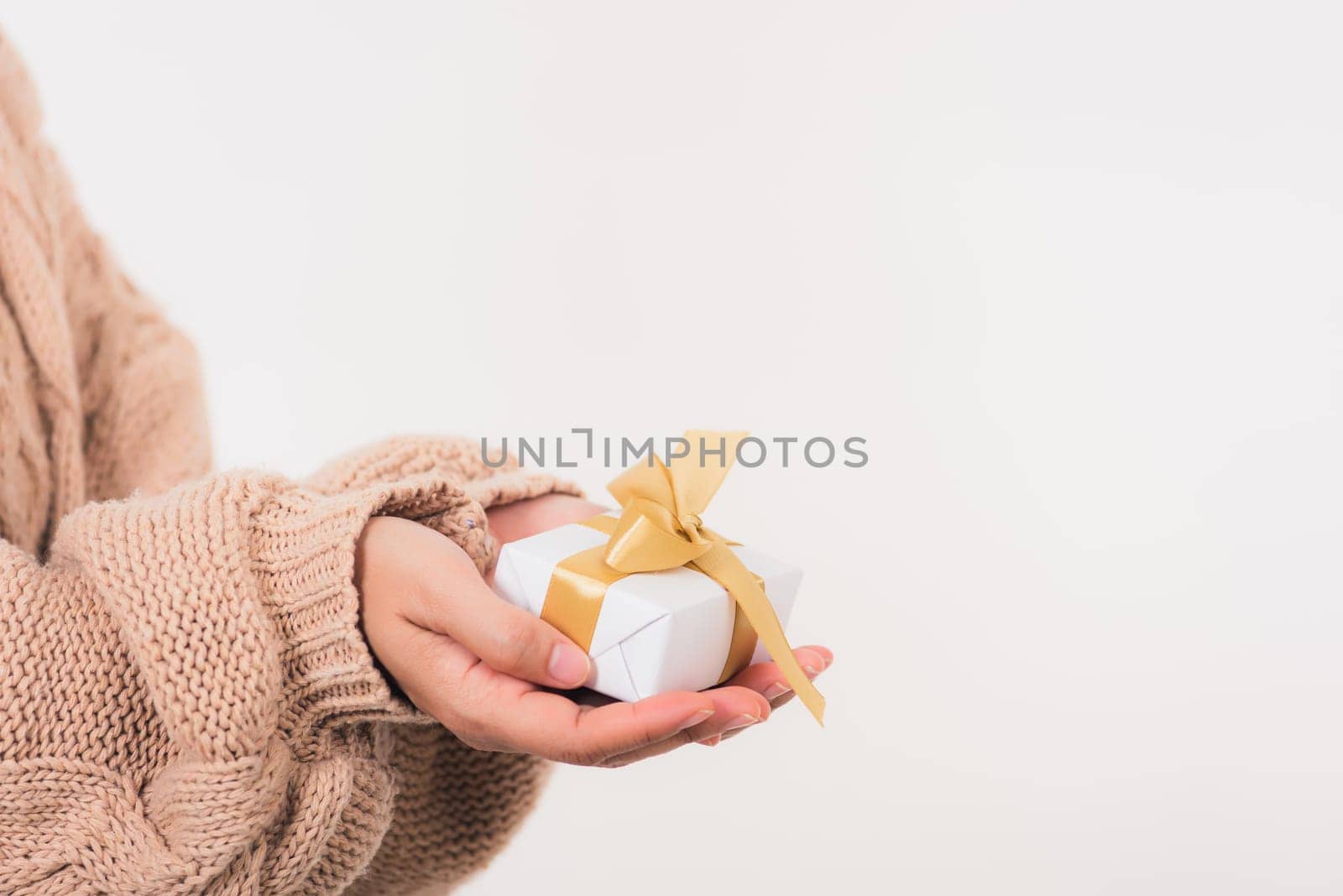 Valentine Day. Woman beauty hands holding small gift package box present wrapped paper with ribbon, Christmas, New year, Birthday holiday background concept
