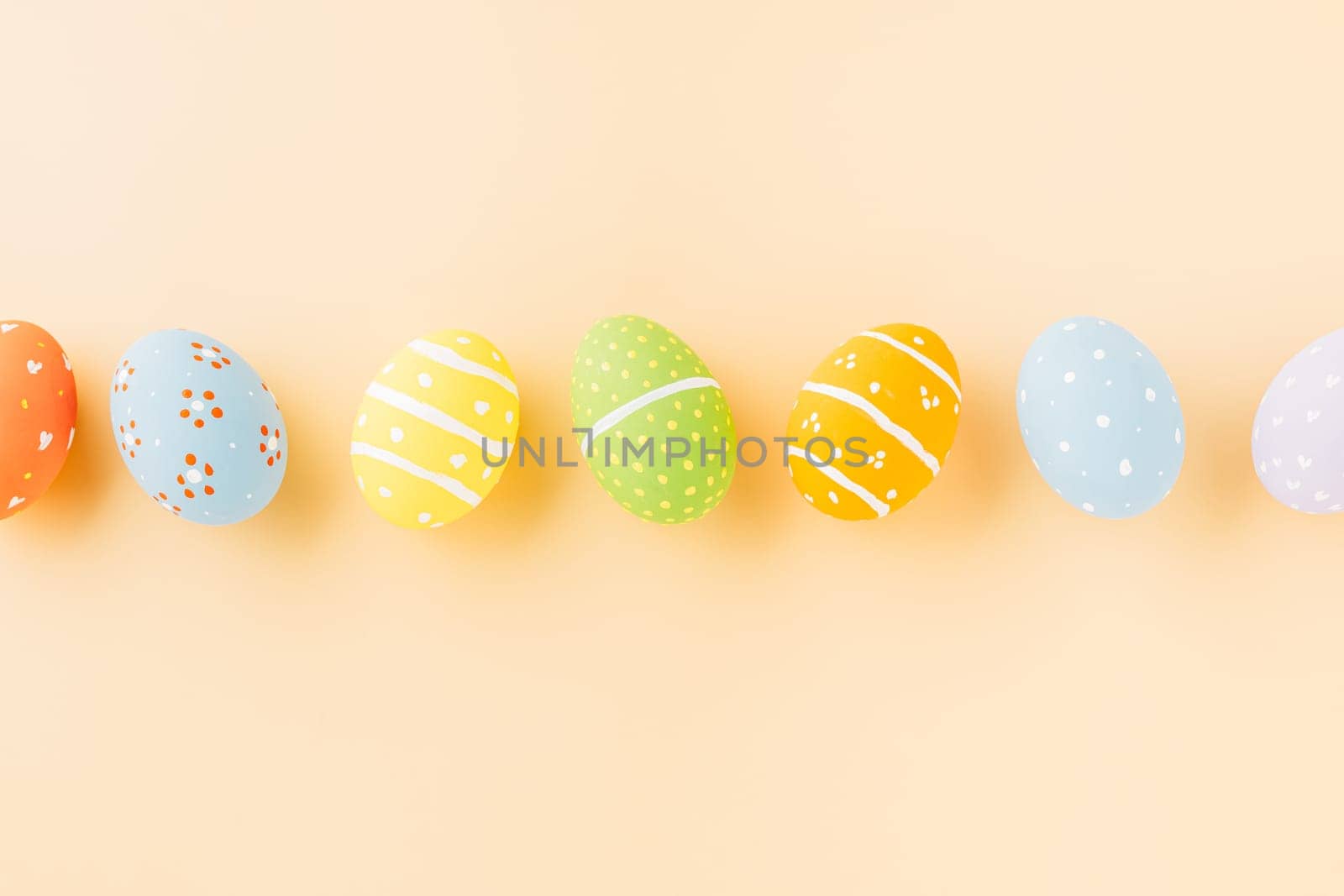 Overhead easter eggs isolated on pastel background with copy space, Funny decoration, Happy Easter Day greeting card, Creative composition banner web design holiday background, flat lay top view