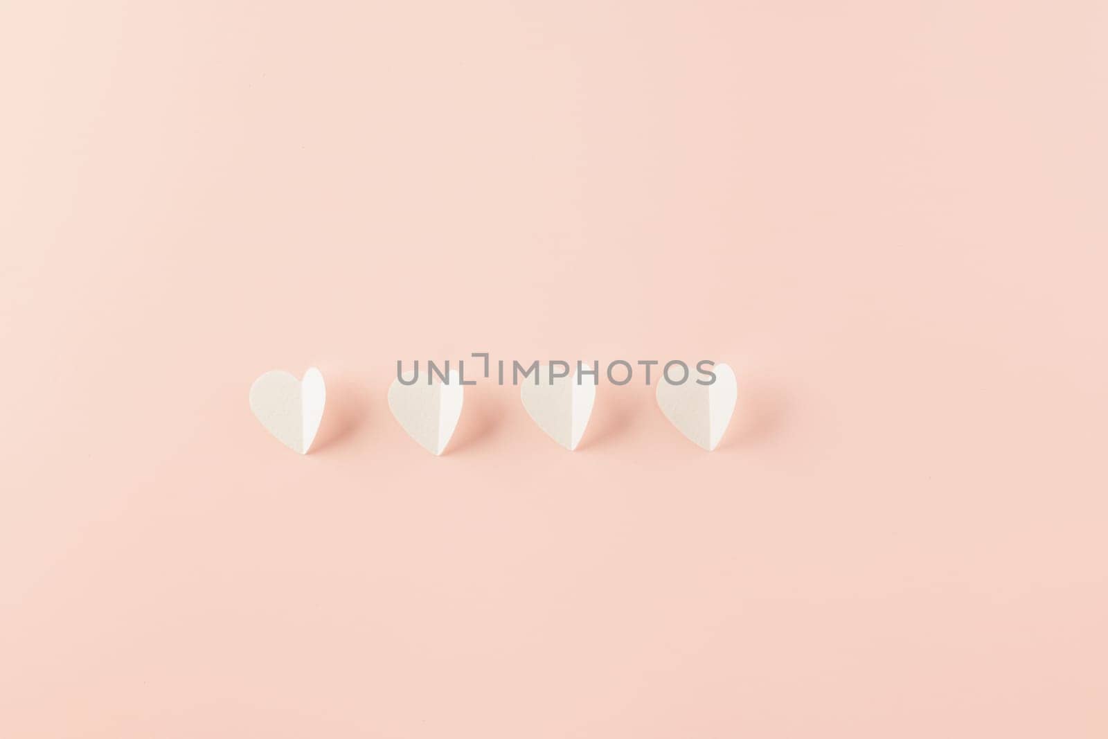 Happy Valentines Day background. Top view flat lay of paper elements cutting white hearts shape flying on pink background with copy space, Happy Mother's Day, Banner template design of holiday