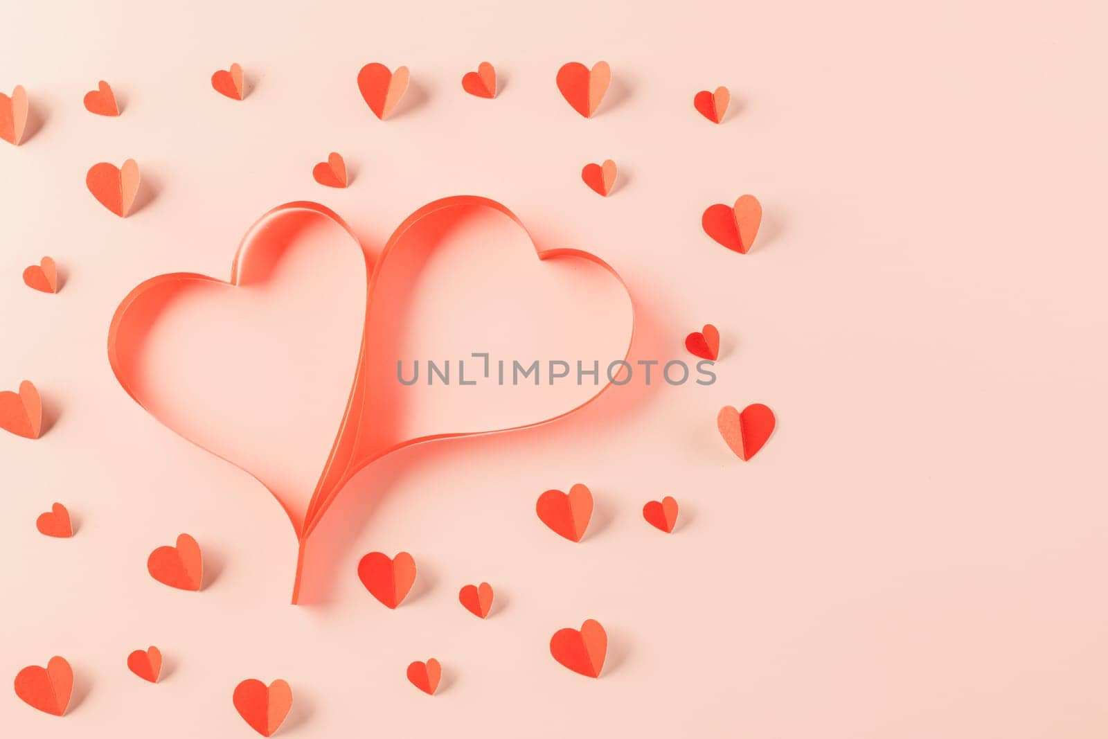 Top view flat lay of Ribbons shaped as heart and paper elements cutting red hearts flying on pink background, Banner template greeting card design of holiday, Love and Valentines Day background