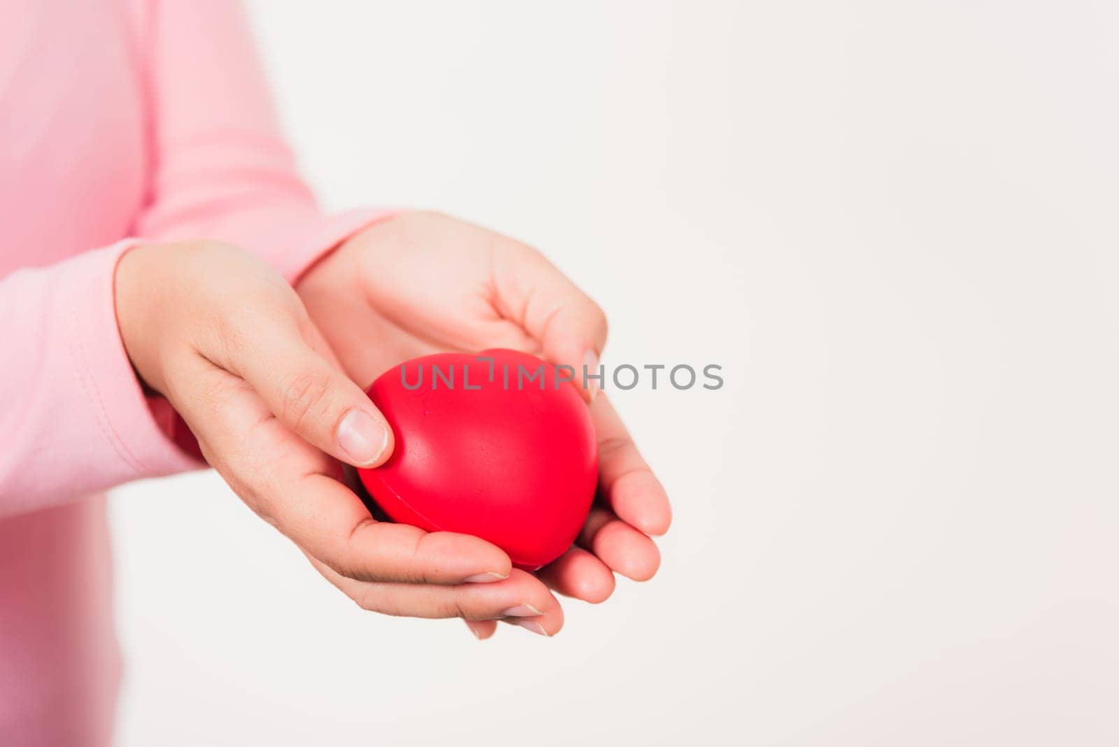Love Valentine's Day. Female beauty hands holding modern a red heart isolated on white background, giving help donation medical healthcare happy holiday background concept