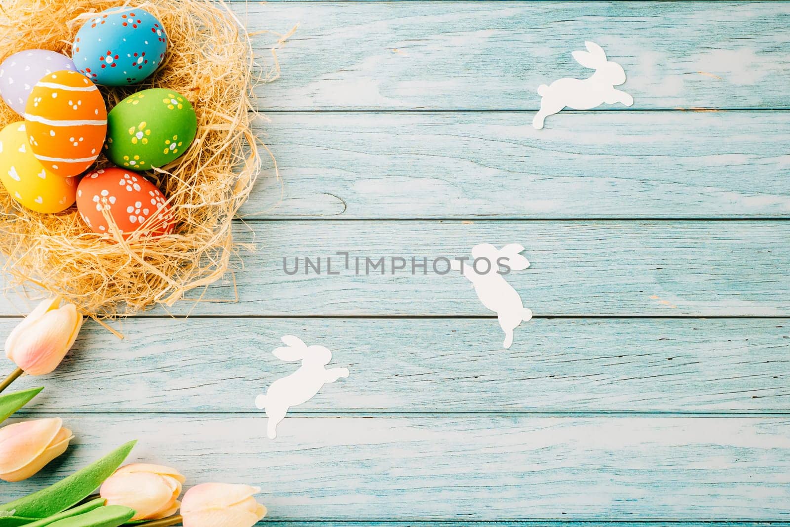 Top view holiday banner background web design white easter eggs in brown nest on blue wooden background with empty copy space, celebration greeting card, overhead, template, Happy Easter Day Concept