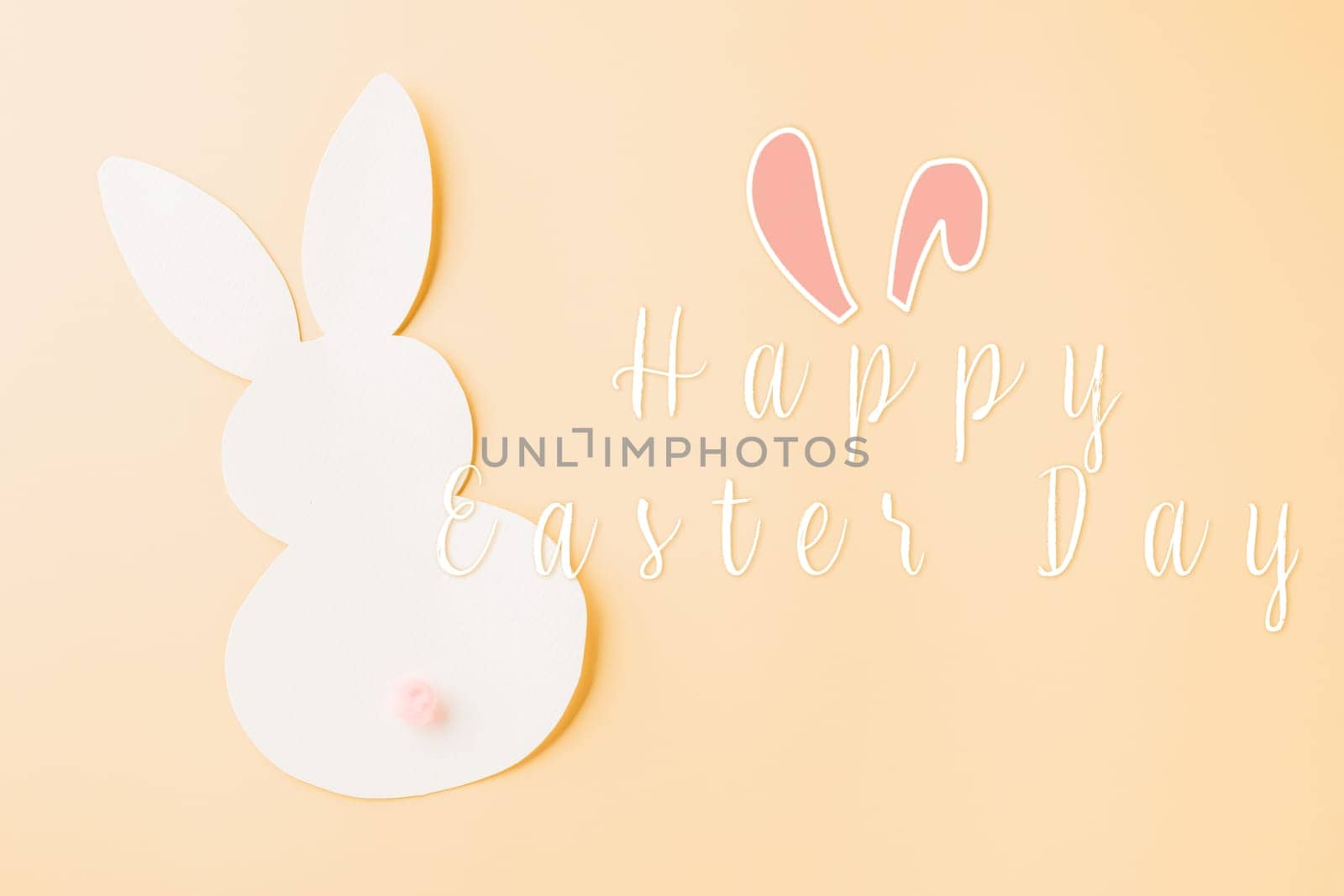 Easter Day Concept. Top view handmade white paper rabbit cutting isolated on pastel background with copy space for your text, Happy Easter Bunny holiday