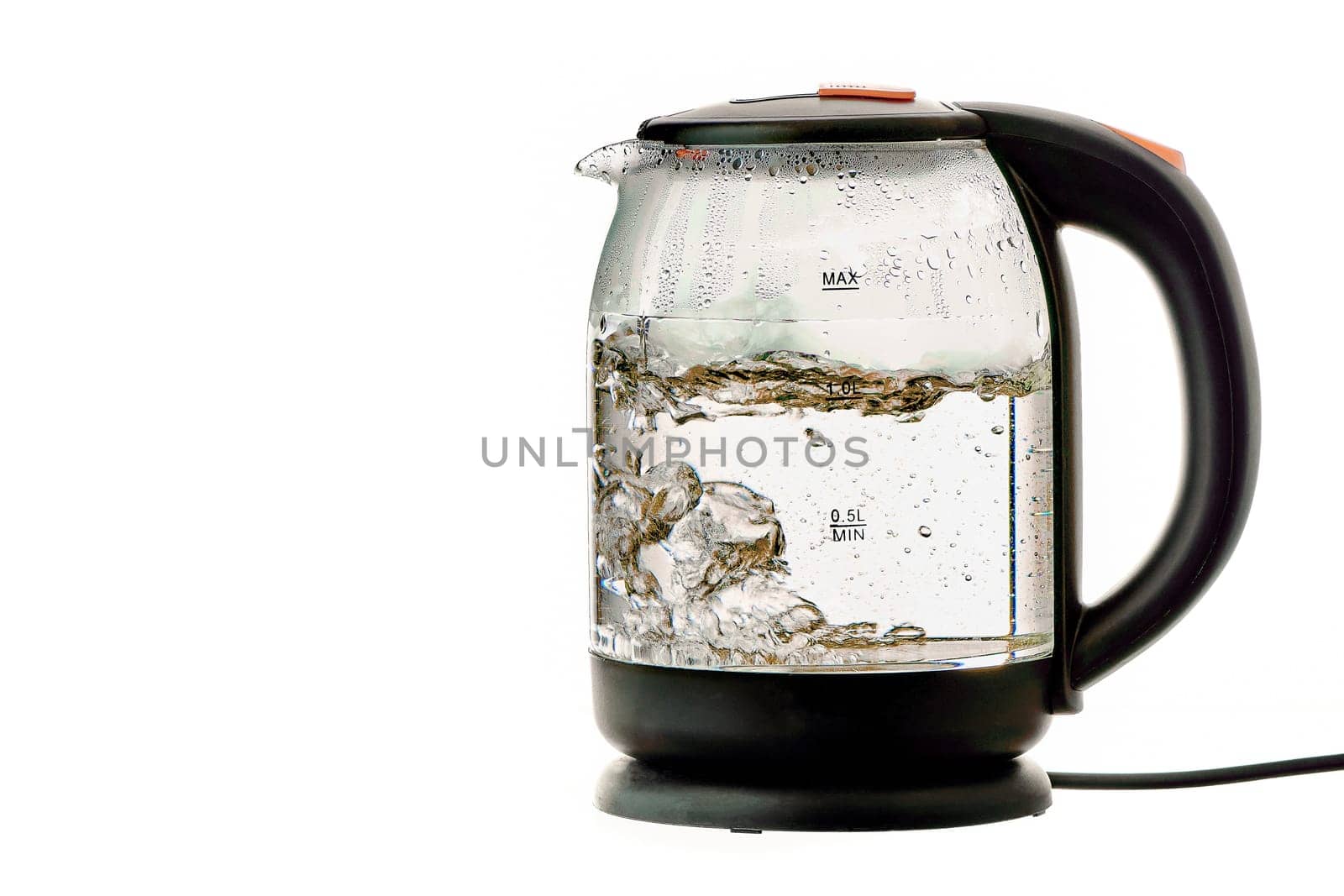 Glass electric kettle with boiling water on a white insulated background. High quality photo