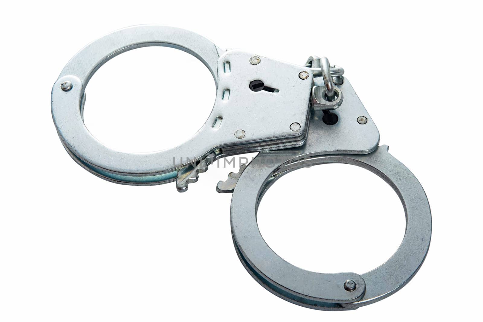 Metal handcuffs on a white isolated background, copy space. High quality photo