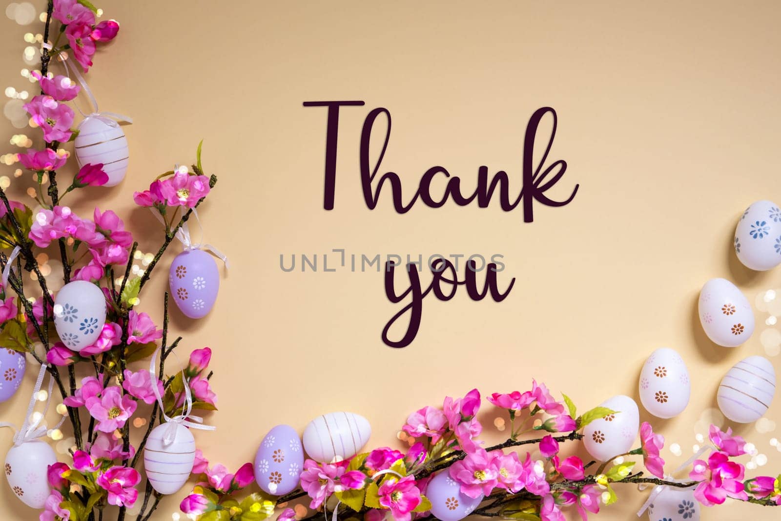 English Text Thank You On Beige Background. Pink And Purple, Shiny And Bright Spring Flower Arrangement With Easter Egg Decoration.
