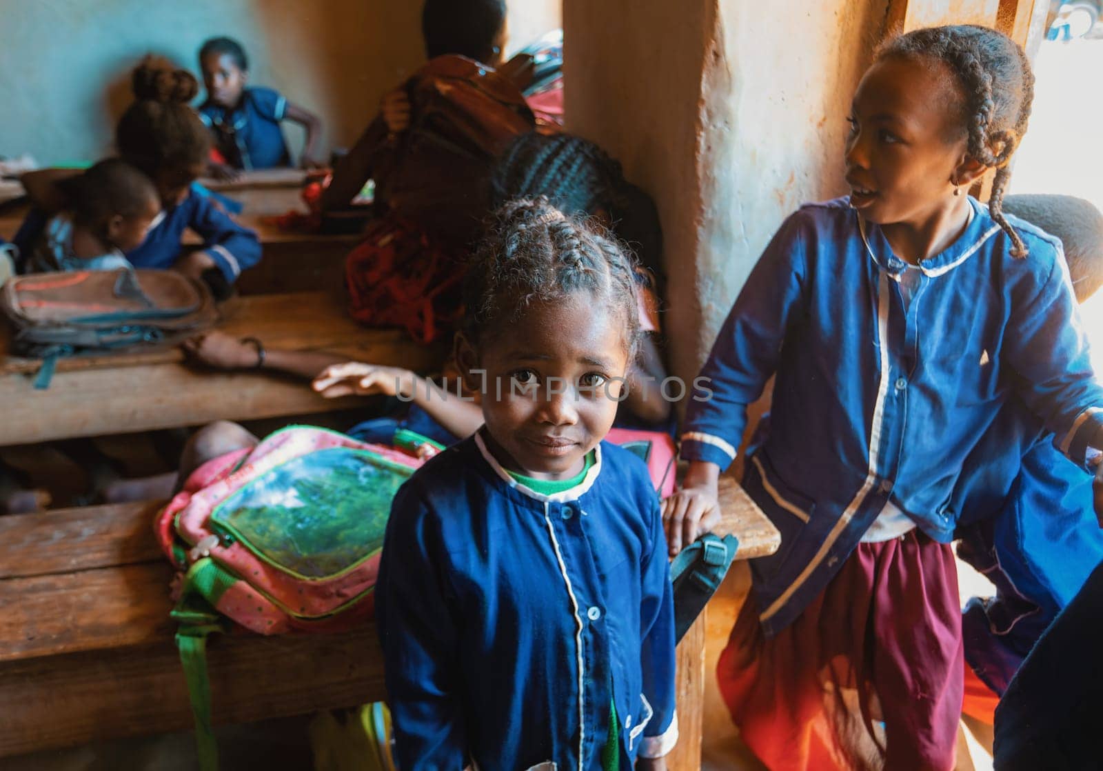 Vohitsaoka, Ambalavao, Madagascar - November 17. 2022: Happy Malagasy school children students in classroom. School attendance is compulsory, but many children do not go to school.