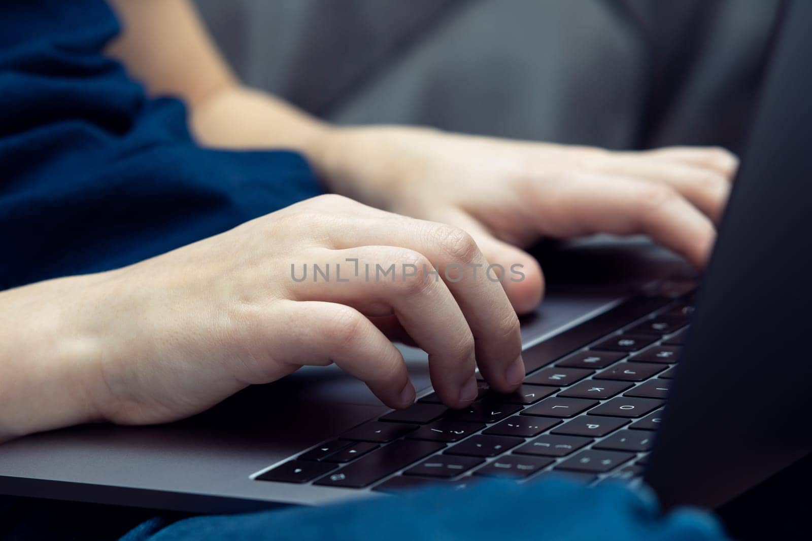Close up unrecognizable man hands typing, using laptop keyboard knees. E-learning and online school, programming, coding application. Freelance occupation, trading and internet technology business.