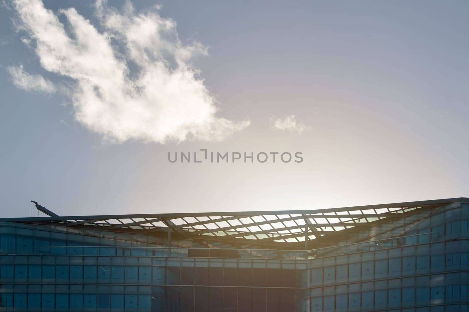 London, United Kingdom - December 03, 2006: Sun backlight over glass and steel office buildings roof ("More London Estates"" design by Foster and Partners). Example of modern architecture in UK capital"