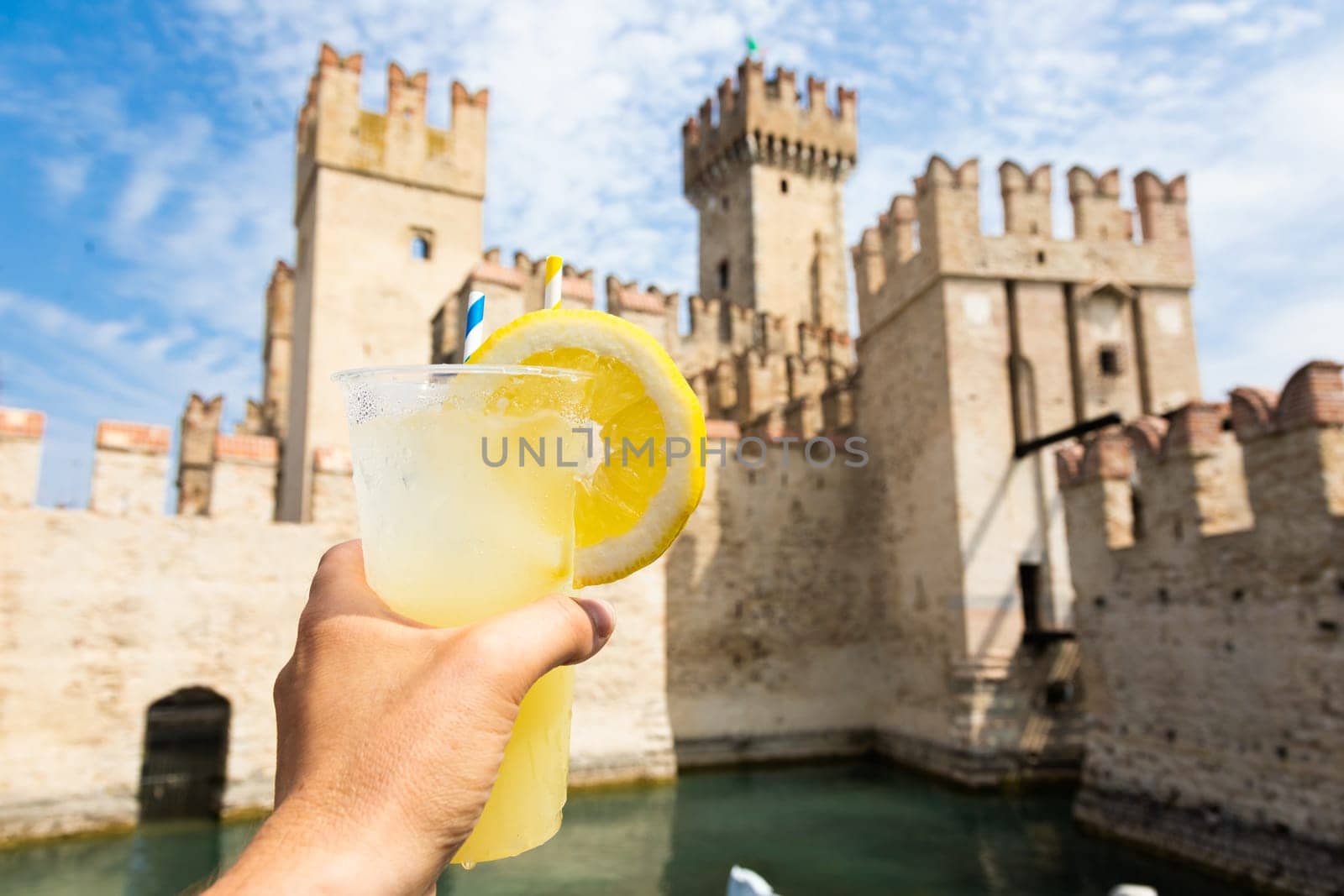 Hand with fresh cold lemonade. Concept for enjoy, relaxation, travel, summer