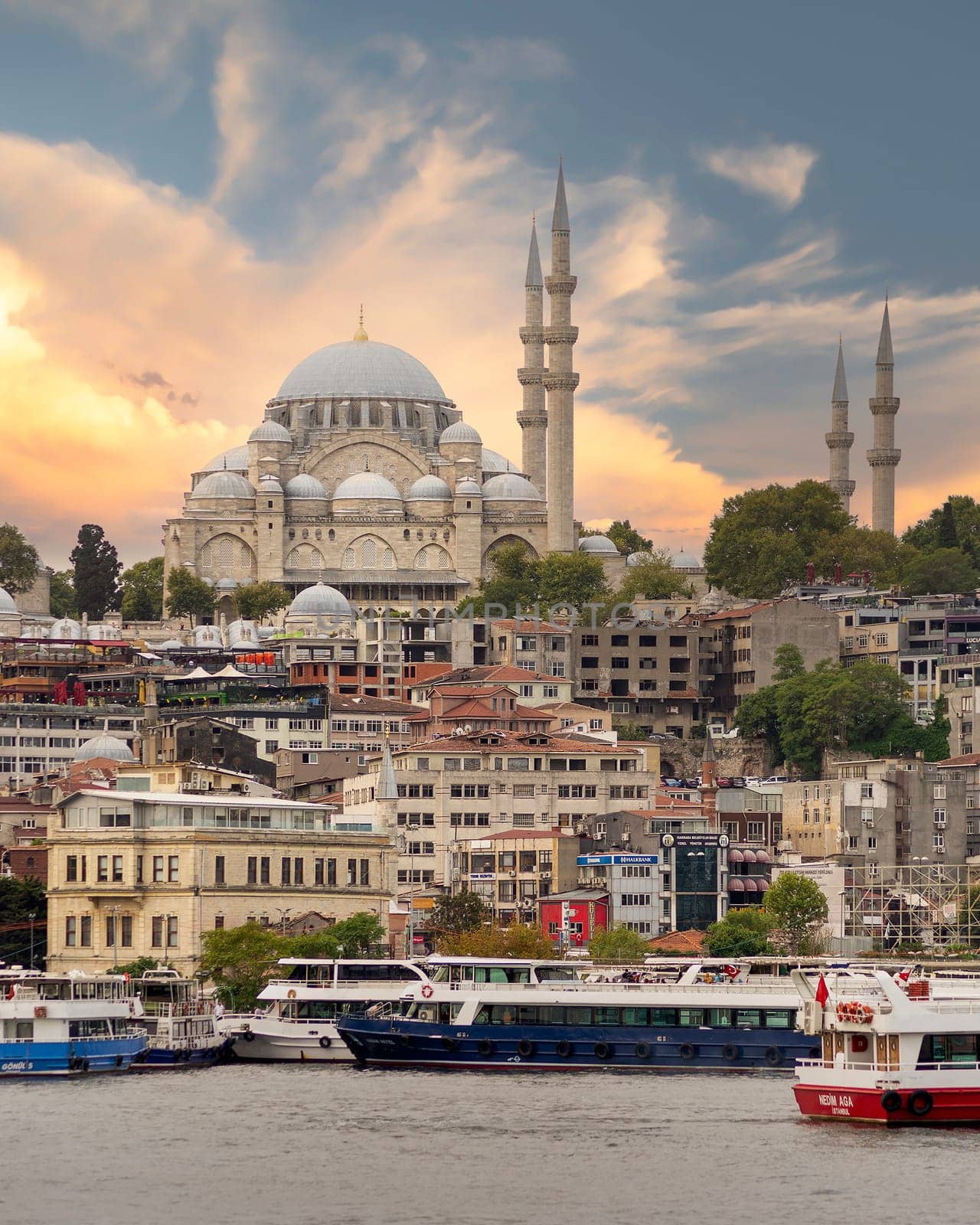Istanbul city view at Eminonu overlooking the Golden Horn with ferries, ferry terminals, and Suleymaniye Mosque before sunset, Istanbul, Turkey