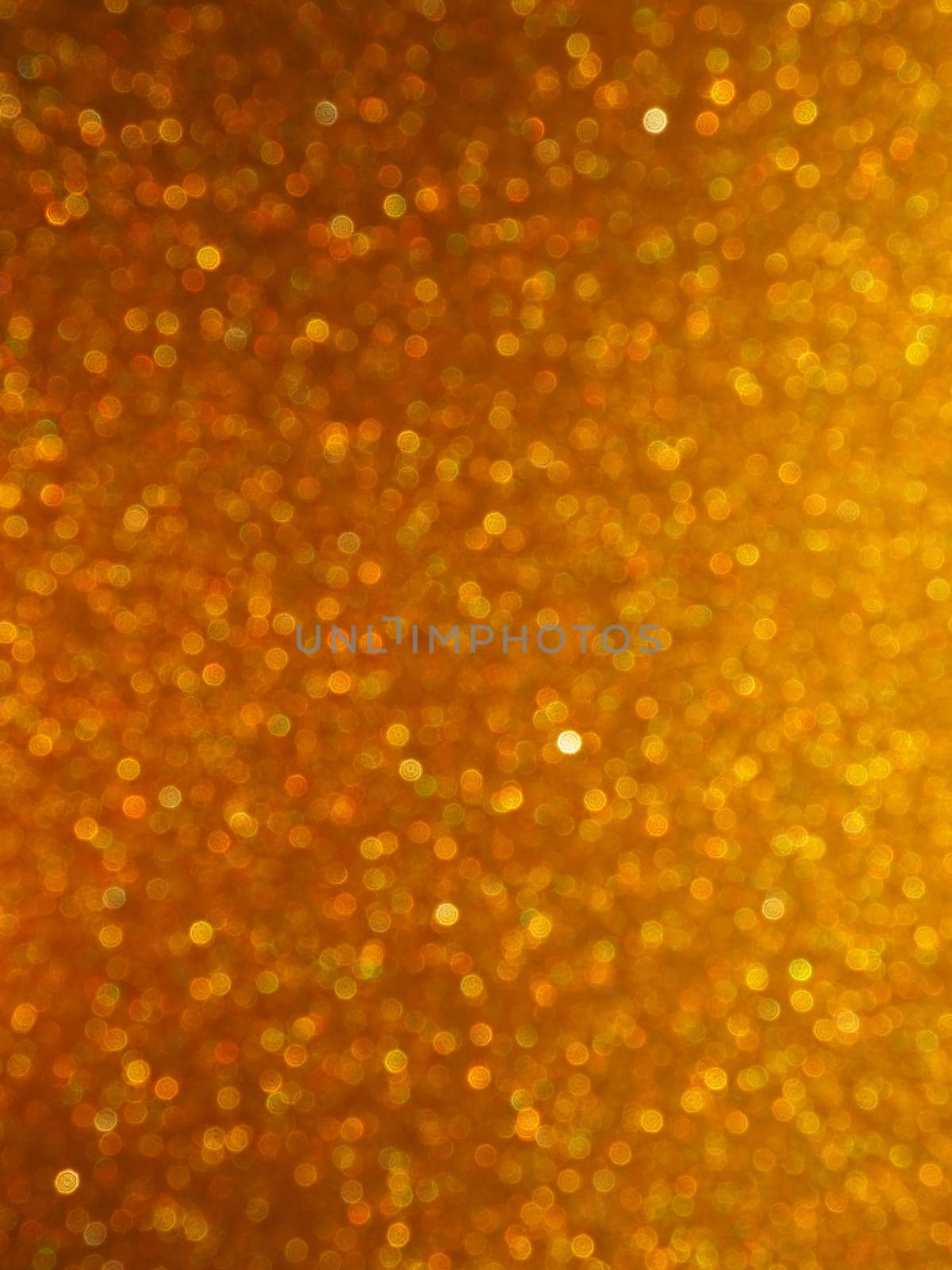 Bokeh light of gold glitters. Golden glitter texture background. Sparkling glitter wrapping paper with sequins and sparkles. Festive golden bokeh and glitter. Beautiful background