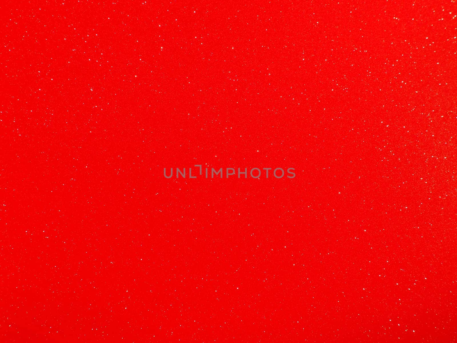 Red background, arched scarlet. Nice holiday color. Background with shimmer, gradient, white dots. Photograph of sparkling colored paper