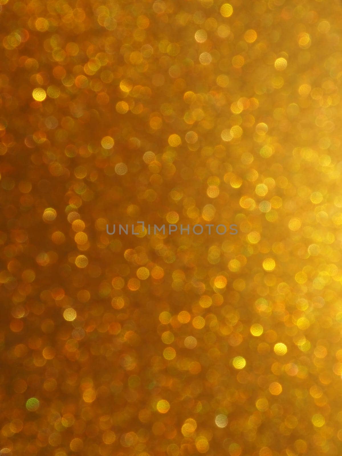 Bokeh light of gold glitters. Golden glitter texture background. Sparkling glitter wrapping paper with sequins and sparkles. Festive golden bokeh and glitter. Beautiful background