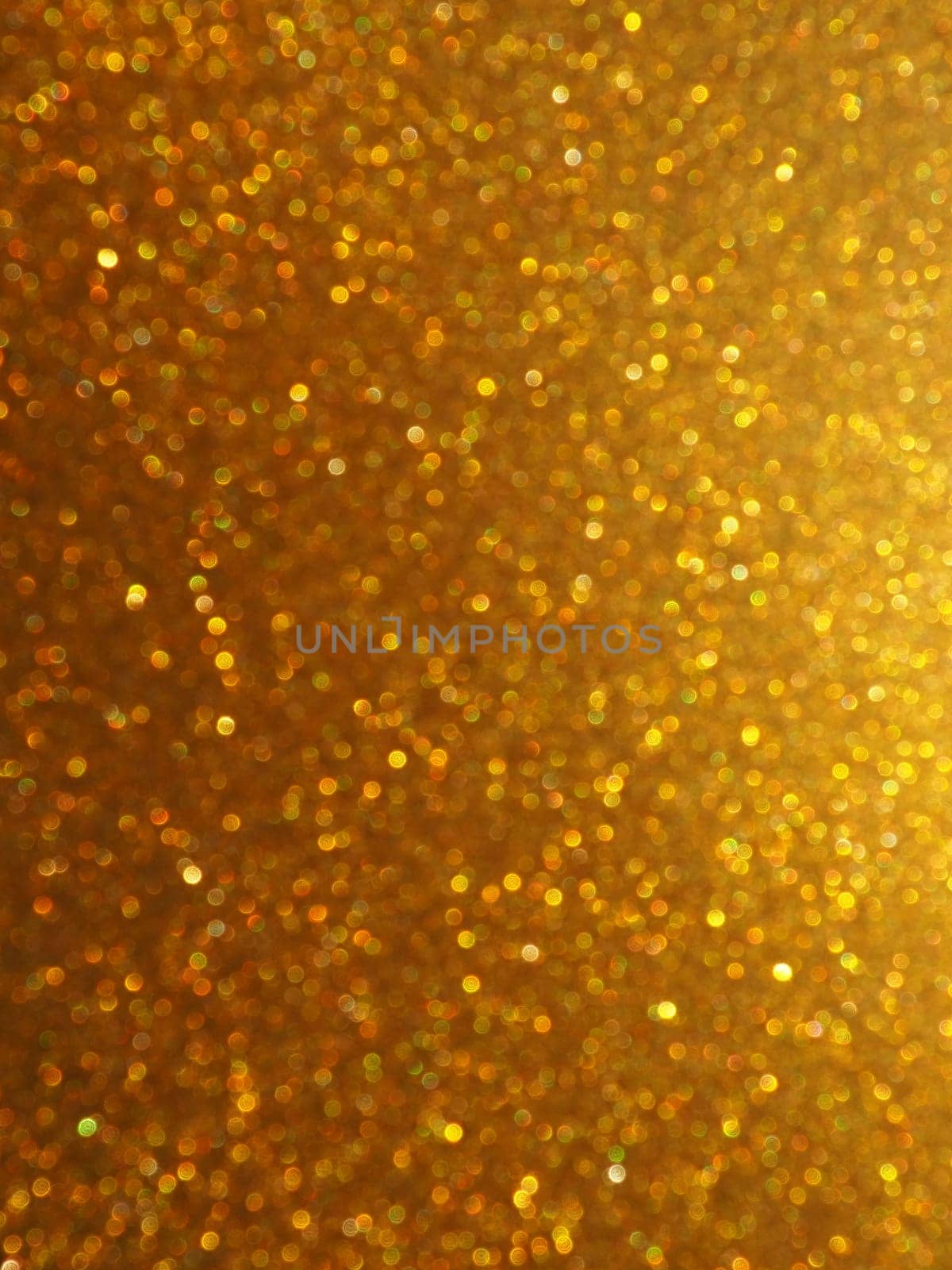 Bokeh light of gold glitters. Golden glitter texture background. Sparkling glitter wrapping paper with sequins and sparkles. Festive golden bokeh and glitter. Beautiful background