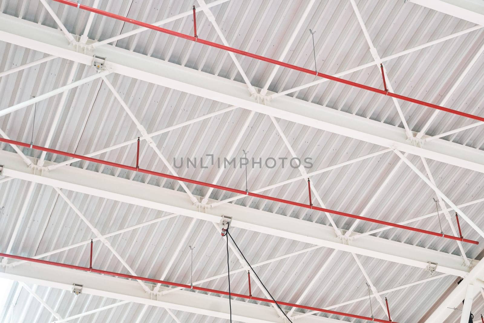 closeup perspective view of interior industrial hangar white steel sustaining roof structure