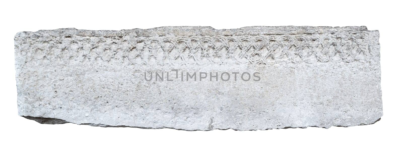 front view closeup of large long antique plaque of stone carved with weathered fading pattern and ragged edges isolated on white