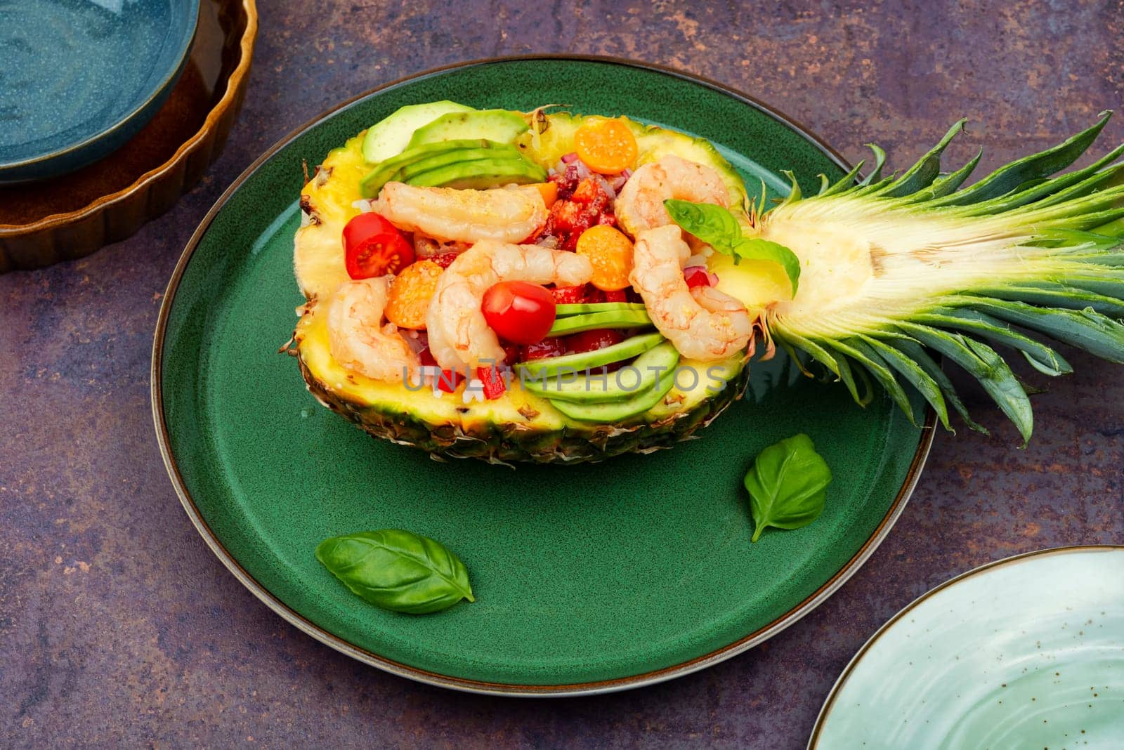 Half a pineapple with vegetables, rice and seafood.Shrimps salad in a pineapple. Asiatic cuisine