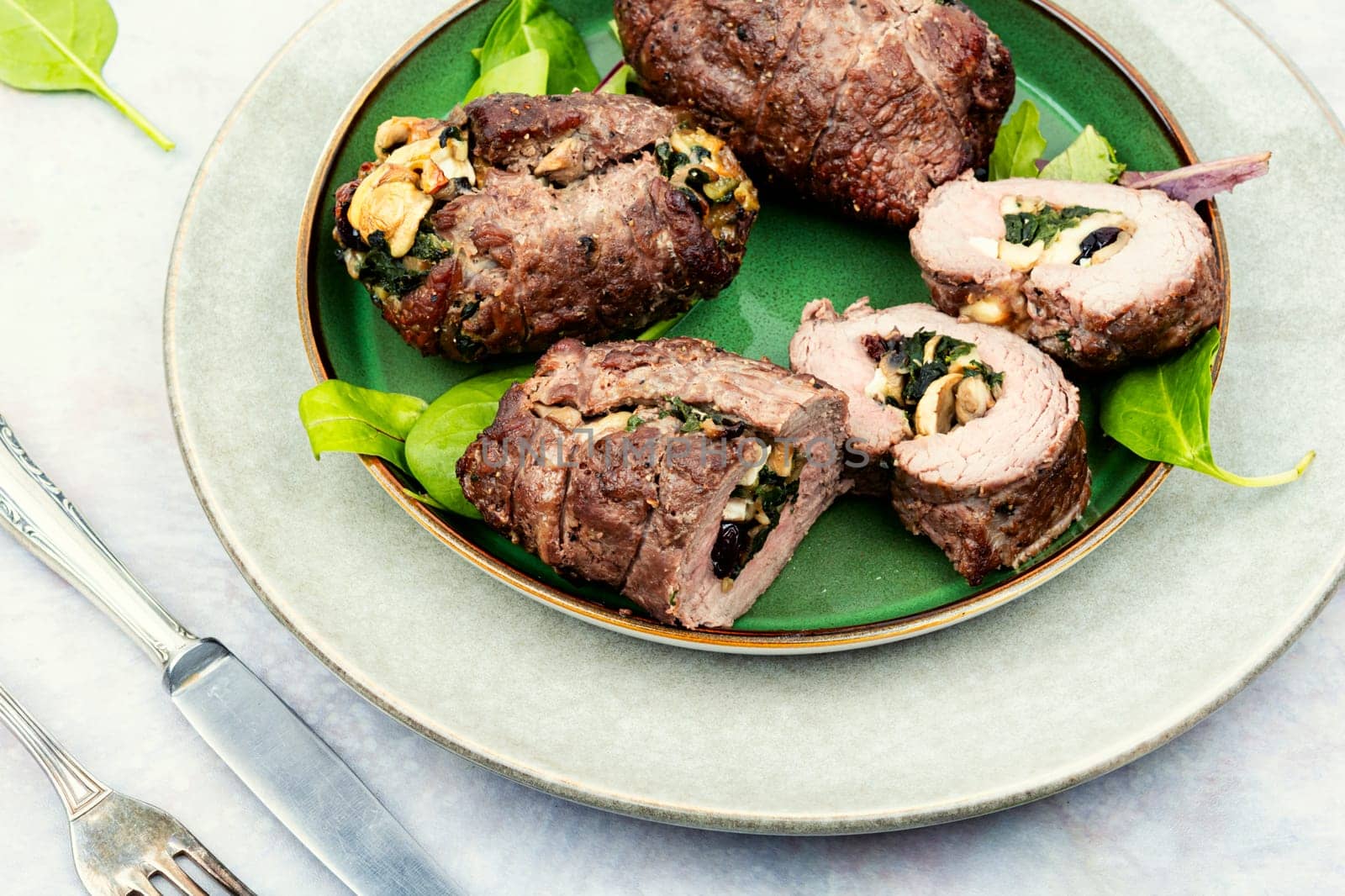 Beef rolls stuffed with mushrooms and herbs. Roasted meat, meatloaf