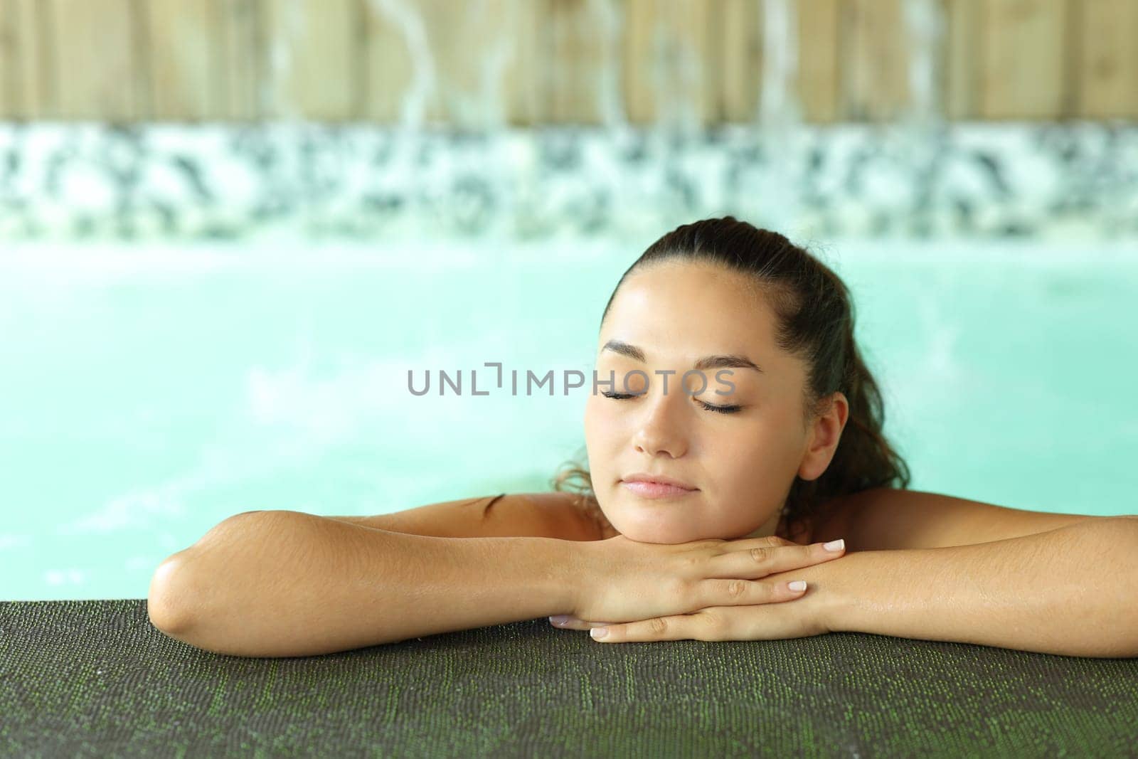 Beautiful woman resting in a spa pool