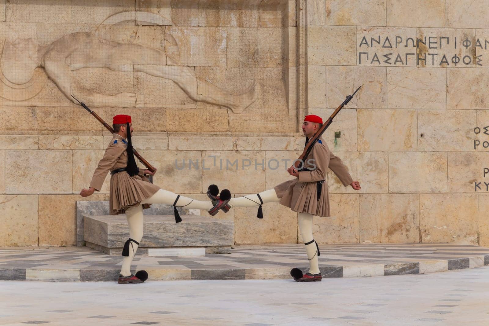 ATHENS, GREECE - MAY 06 2022: Presidential ceremonial guards - Evzones at the Tomb of the Unknown Soldier in front of the Greek Parliament, Athens, Greece