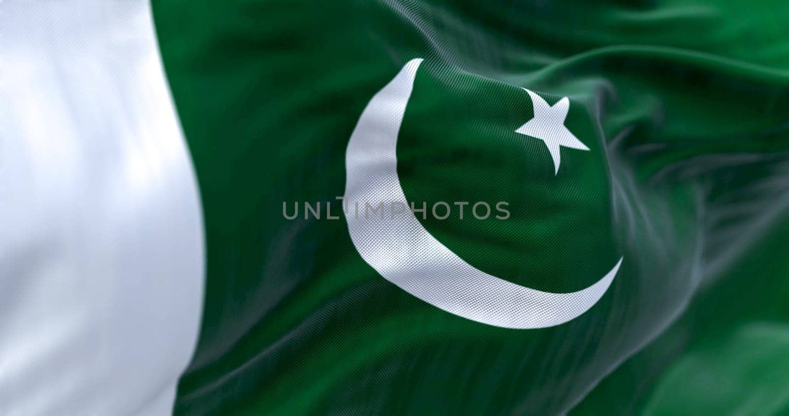 Detail of of Pakistan National flag waving. Green with white band on hoist  white crescent moon and five-pointed star. 3d illustration render. Selective focus. Close-up. Textured background