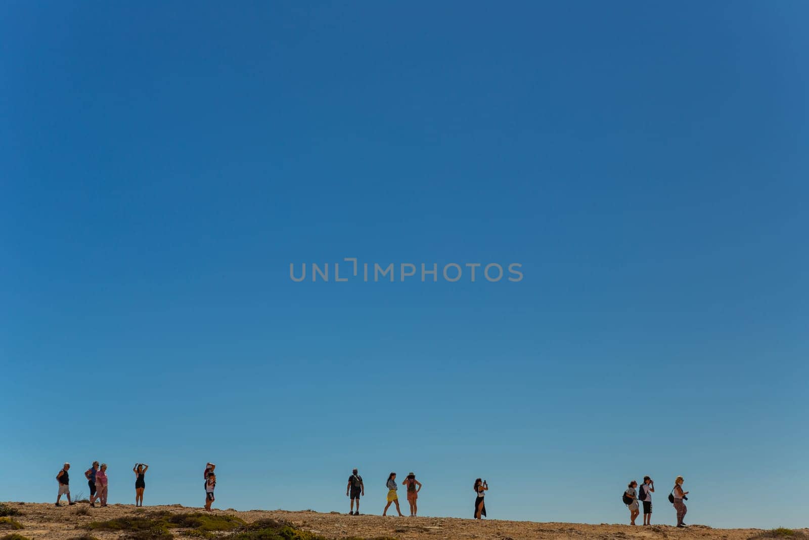 Sagres, Portugal - August 25, 2022: People at the cliff in Sagres village in Algarve, Portugal